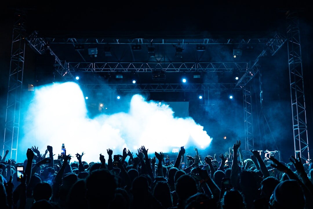 Concert stage with colorful lights and a crowd